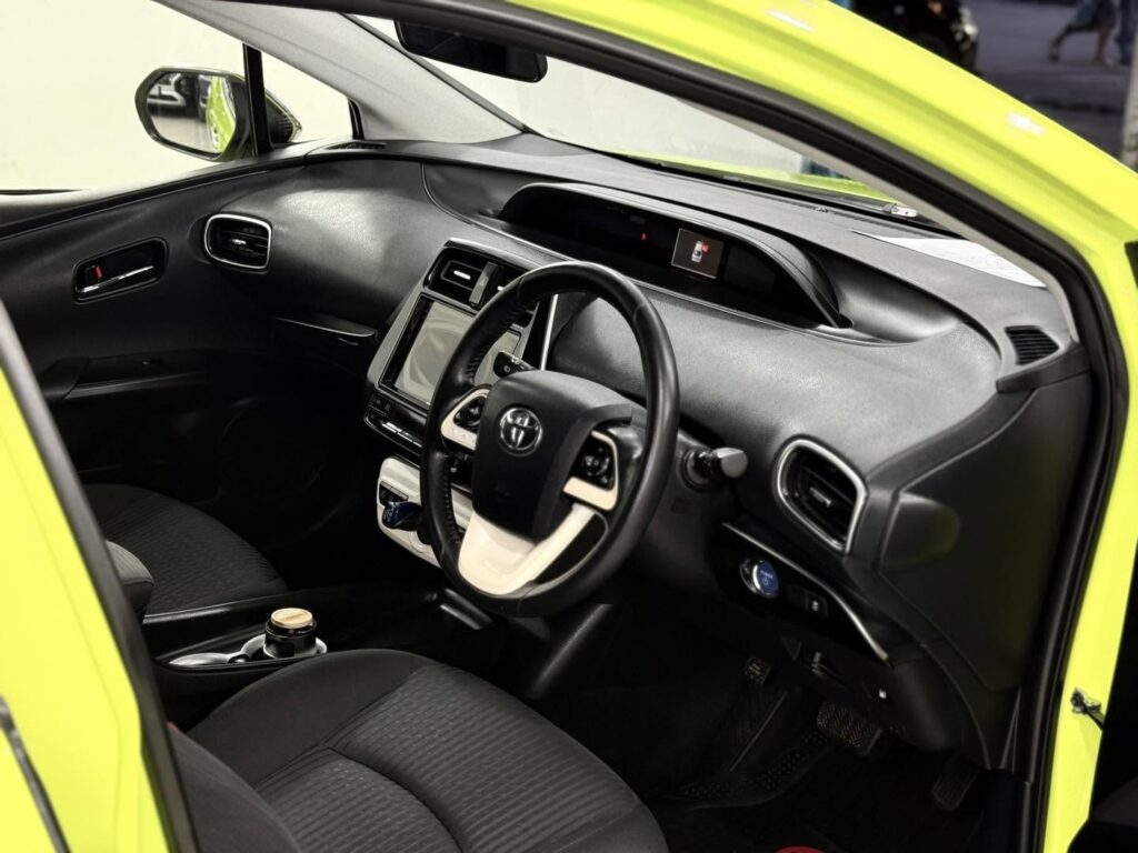 Used Car For Sale in Dhaka showing the spacious rear seats and cupholder of a Toyota Prius